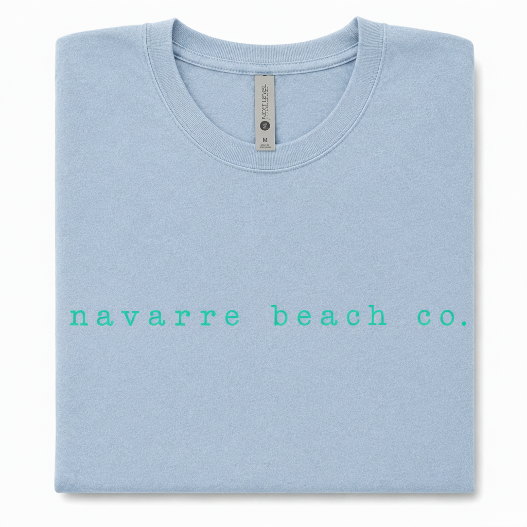 Navarre Beach Co. tee with crisp turquoise lettering on a light blue shirt